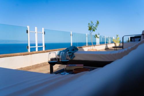 a bed on top of a roof with a view of the ocean at Villa Zagara Garden Spectacular Sea View in Taormina in Taormina