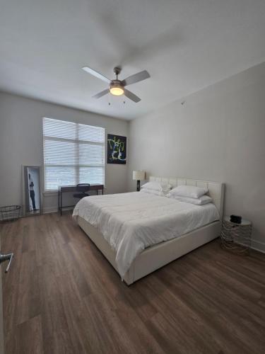 a bedroom with a bed and a ceiling fan at 2bdrm/2 King beds/1Air mattress in Dallas