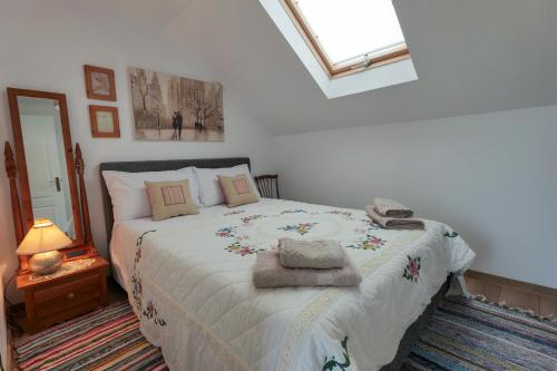 a bedroom with a large bed with towels on it at La Moviliță in Somova