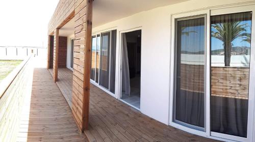 a balcony with sliding glass doors on a house at THALASSA BOUTIQUE HOTEL in Sarti