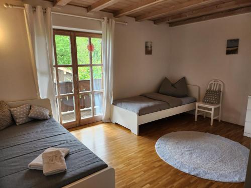 a room with a bed and a couch and a window at Ferienhaus Bad Feilbach in Bad Feilnbach