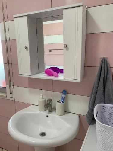 a bathroom with a sink and a mirror at Ridi's Comfort Apartment 2 in Shkodër