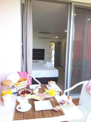 a table with food on it in a room with a bed at THALASSA BOUTIQUE HOTEL in Sarti