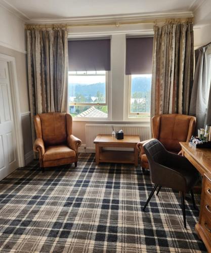 a living room with two chairs and a table at The Ryebeck Hotel in Bowness-on-Windermere