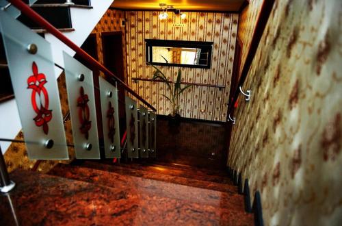 a hallway with a stairway with a stair railing at Silver in Hunedoara