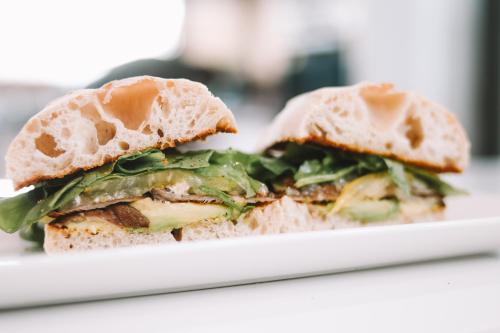 a sandwich is cut in half on a plate at Catriel Suites in Catriel