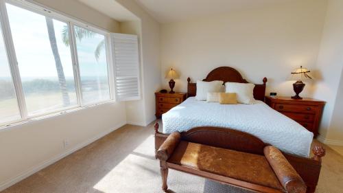 a bedroom with a bed and a large window at MAJESTIC OCEAN Majestic Mauna Kea Condo with Golf and Ocean Views in Hapuna Beach