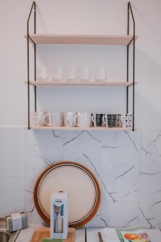 a mirror on a wall next to a counter at MASAL Studio Apartman in Bihać