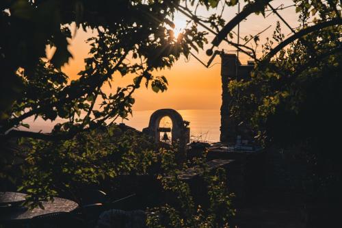 a view of the sunset from a garden with trees at Le Signorine Panoramic apartments in Gratteri