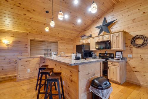 a kitchen with a large center island in a log cabin at Private Hot Tub Gatlinburg Cabin in the Clouds in Gatlinburg