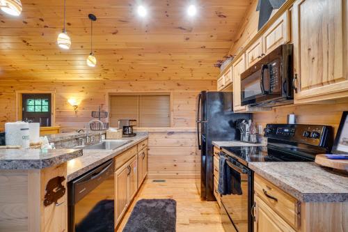 a large kitchen with wooden cabinets and counters at Private Hot Tub Gatlinburg Cabin in the Clouds in Gatlinburg