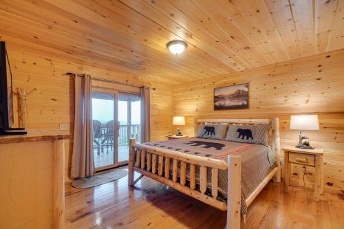 a bedroom with a bed in a log cabin at Private Hot Tub Gatlinburg Cabin in the Clouds in Gatlinburg