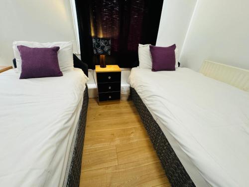 two beds sitting next to each other in a room at Burlington West hotel in Blackpool