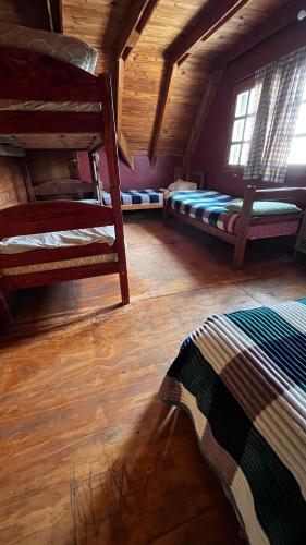 a room with two bunk beds and a window at Hebes House in Caviahue