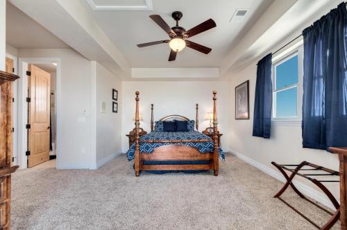 a bedroom with a bed and a ceiling fan at Summit Villa BnB in Watkins