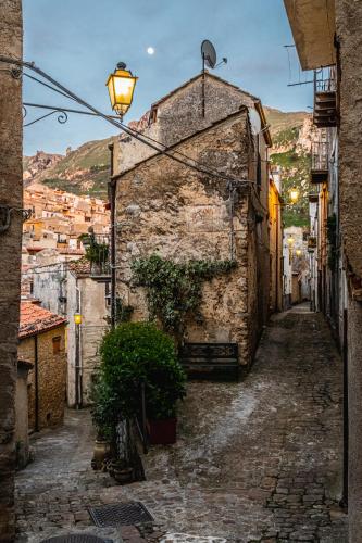 an alley in an old town with a street light at Case Ruggieri Luxury apt - Don Pietro in Gratteri