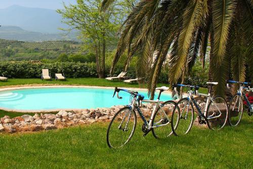 two bikes parked next to a swimming pool at Hotel Villa Gli Asfodeli in Tresnuraghes