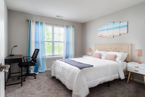 a bedroom with a bed and a desk and a window at Corporate Housing by MGM in Gurnee