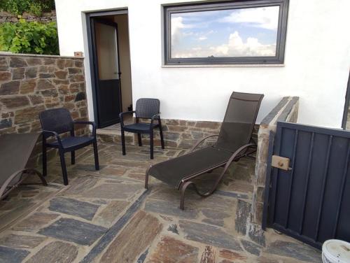 a patio with chairs and a window on a building at Grande Vista Douro in Valença do Douro