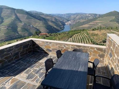 una mesa y sillas en un balcón con vistas en Grande Vista Douro, en Valença do Douro