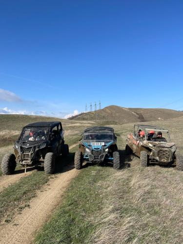 a group of three atvs and two atvs on a dirt road at mood villa Kazbegi in Stepantsminda
