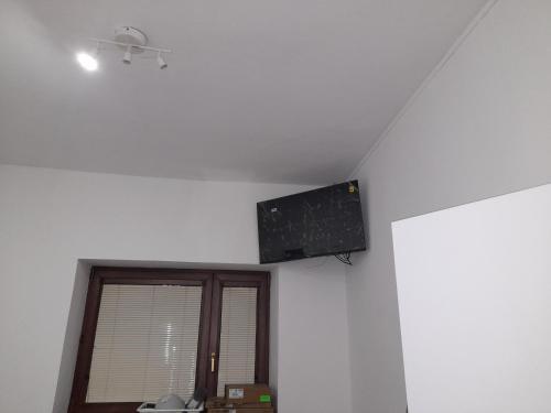 a speaker on the ceiling of a room with a window at Apartments Vančurova private parking in Brno
