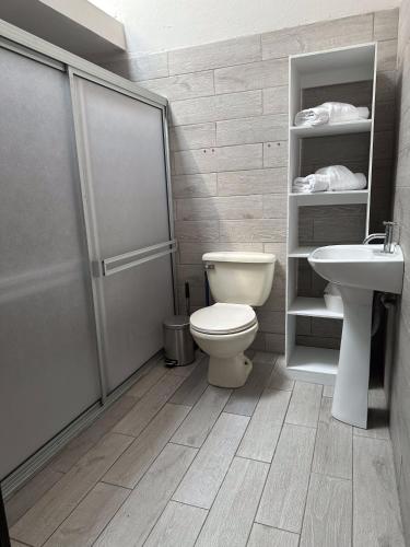 a bathroom with a toilet and a sink at Casa Buen Agüero in San Antonio