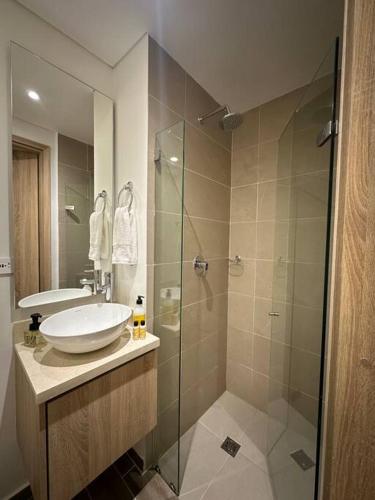 a bathroom with a sink and a glass shower at Apartamento Duplex Centro Histórico in Cartagena de Indias