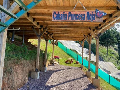 a wooden pavilion with a sign that reads caterpillar princess rode at Cabaña Princesa Roja - PERFECT view of the valley! in San Pablo