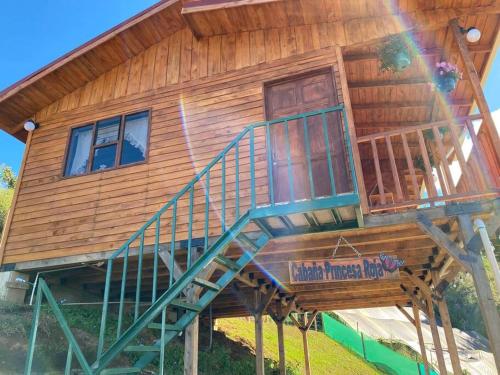 a large wooden house with a staircase on it at Cabaña Princesa Roja - PERFECT view of the valley! in San Pablo
