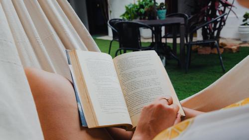 a person is reading a book in a chair at CASA MAGIA by Magally Velasco in Curití