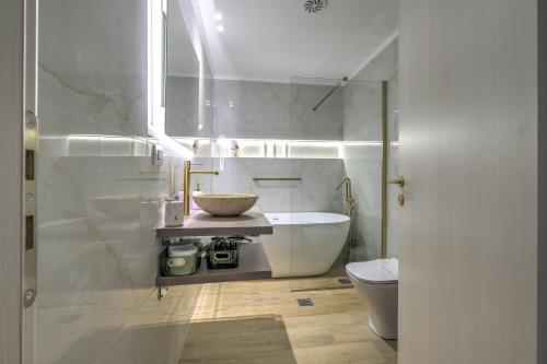 a bathroom with a tub and a sink and a toilet at Marie Suite in Nafplio