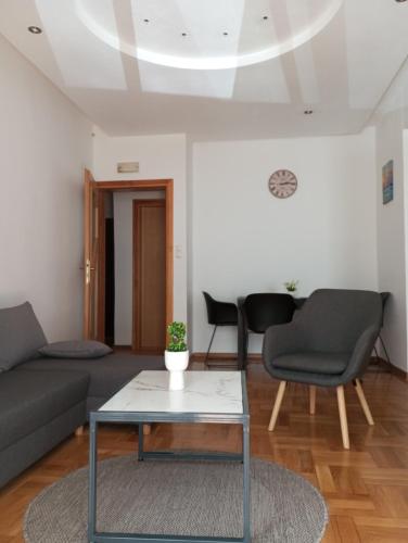 een woonkamer met een bank, stoelen en een tafel bij Apartman Nika in Mostar