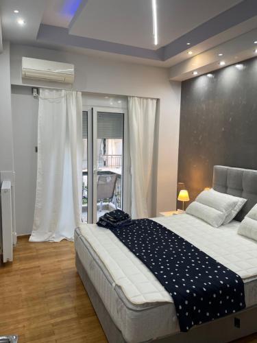 a bedroom with a large bed and a window at Maria's luxury apartment in Athens