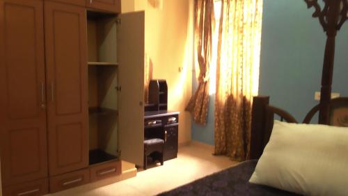 a bedroom with a bed and a cabinet with a television at Fumba House BnB in Fumba