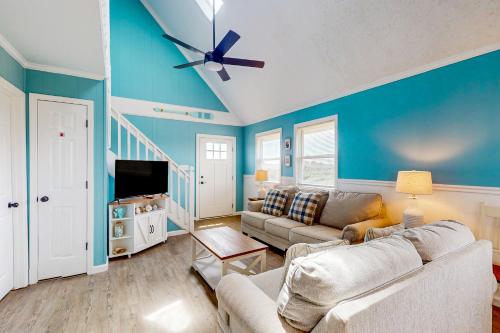 a living room with a couch and a ceiling fan at Wright At Home in Rodanthe