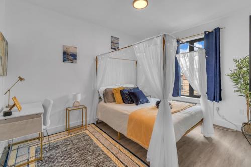 a bedroom with a bed with a canopy at Royal Oasis Indoor Pool, FREE Parking, Near NYC in Elizabeth