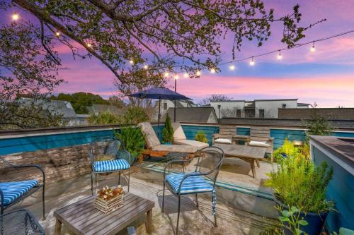 a patio with a couch and chairs and a table at Elegant Sunlit Home with Private Rooftop Oasis in Charleston
