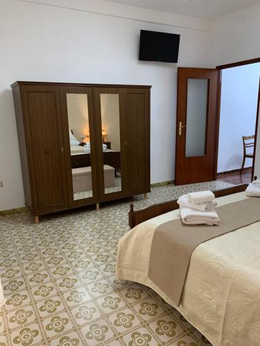 a hotel room with a bed and a television in it at Il Nido in Collina in Caiazzo