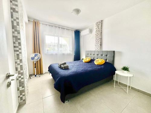 a bedroom with a blue bed with two pumpkins on it at Stay With Oleg C111 in Paralimni