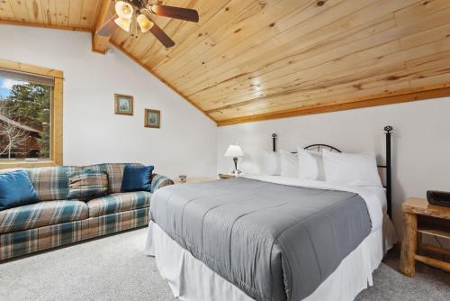 a bedroom with a large bed and a couch at Bugle Pointe A06 by Estes Park Condos in Estes Park