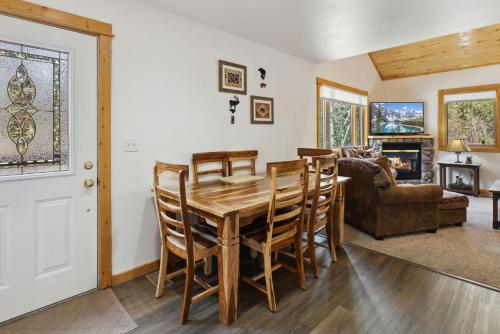 a kitchen and living room with a wooden table and chairs at Bugle Pointe A06 by Estes Park Condos in Estes Park
