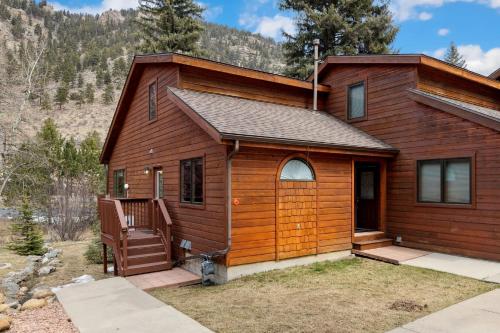 a log cabin with a porch and a deck at Bugle Pointe A06 by Estes Park Condos in Estes Park