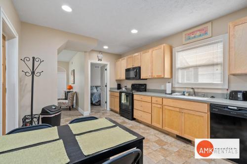 a kitchen with wooden cabinets and a table with chairs at Downtown Holland Charmer in Holland