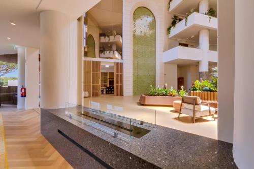 a lobby with a glass counter in a building at Falésia Hotel - Adults Only in Albufeira