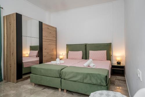 a bedroom with a large bed and a mirror at NEON 2BR Luxurious Central Apt Heraklion in Heraklio Town