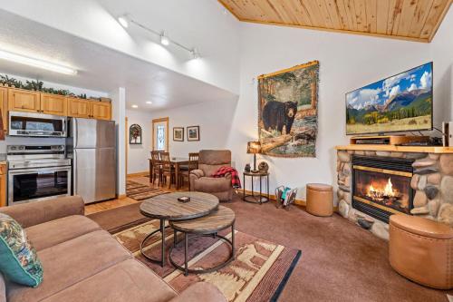 a living room with a couch and a fireplace at Bugle Pointe A10 by Estes Park Condos in Estes Park