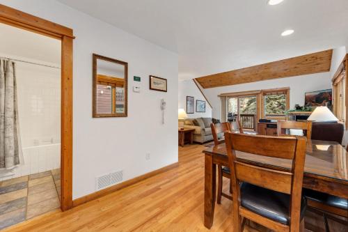 a dining room and living room with a table and chairs at Bugle Pointe A11 by Estes Park Condos in Estes Park