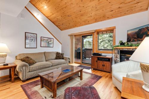 a living room with a couch and a table at Bugle Pointe A11 by Estes Park Condos in Estes Park