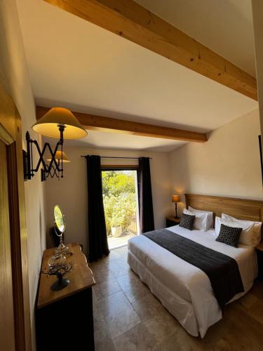 a bedroom with a large bed and a window at Villa Madra in Bonifacio